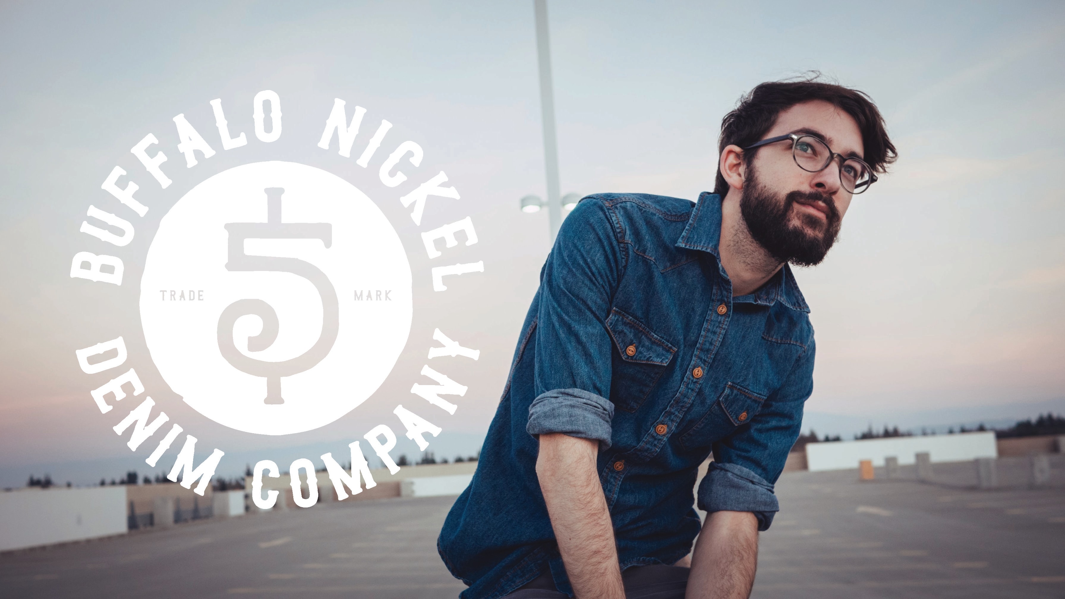 Man in denim shirt rooftop portrait
